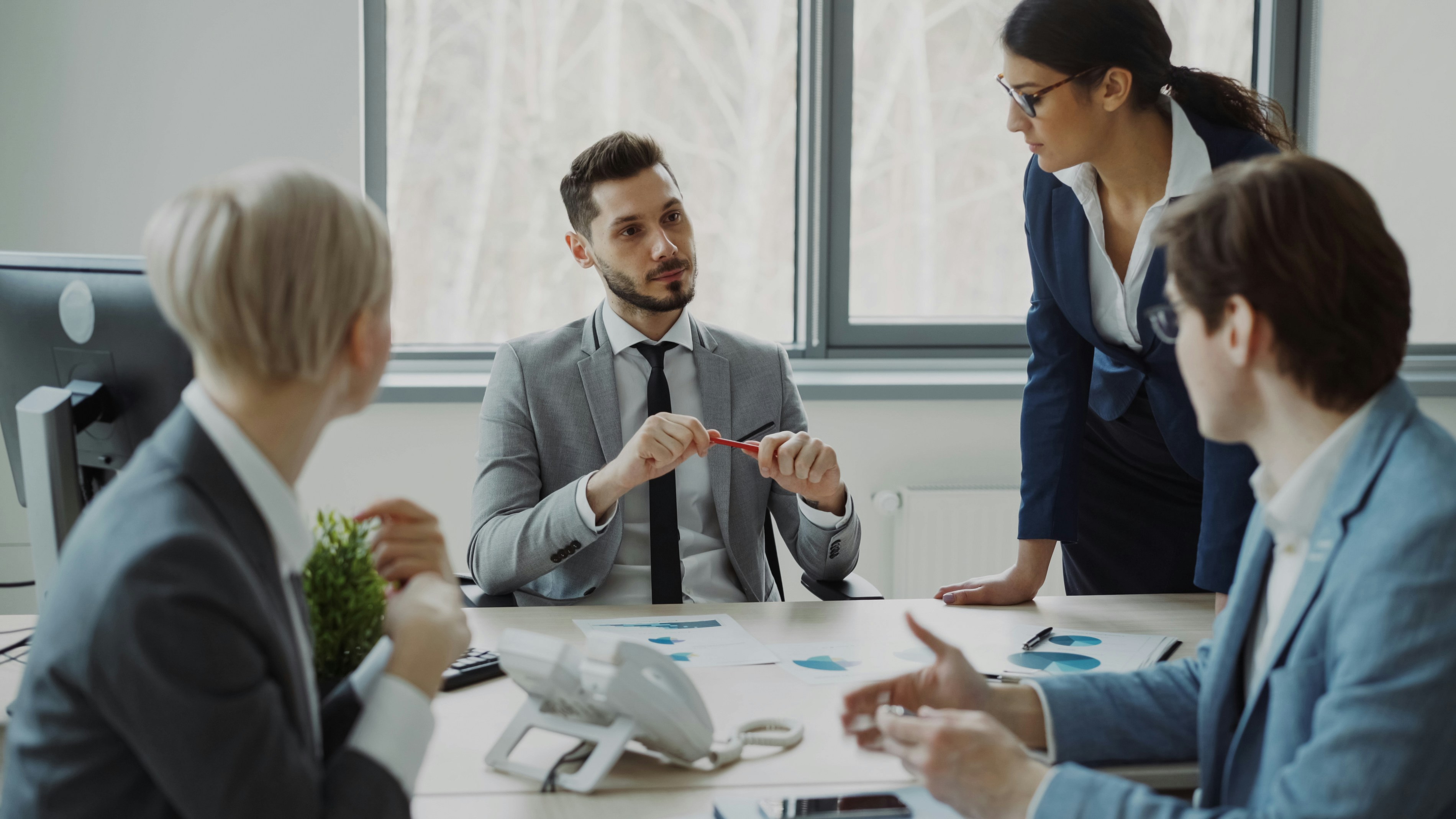 🎬 FULL 4K VIDEO for this still is in my bio link! ⬇️ Young businessman talking with male and female colleagues sitting at the table in modern office indoors